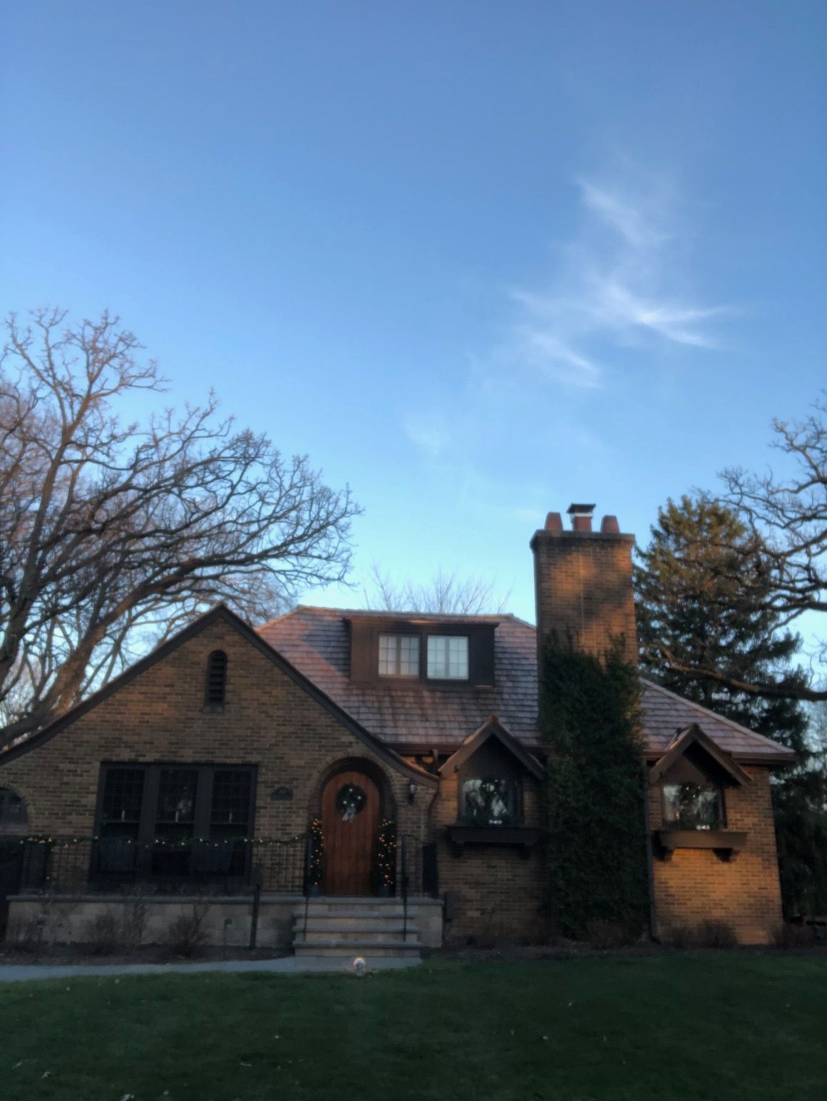 A large brick house with a chimney on the roof