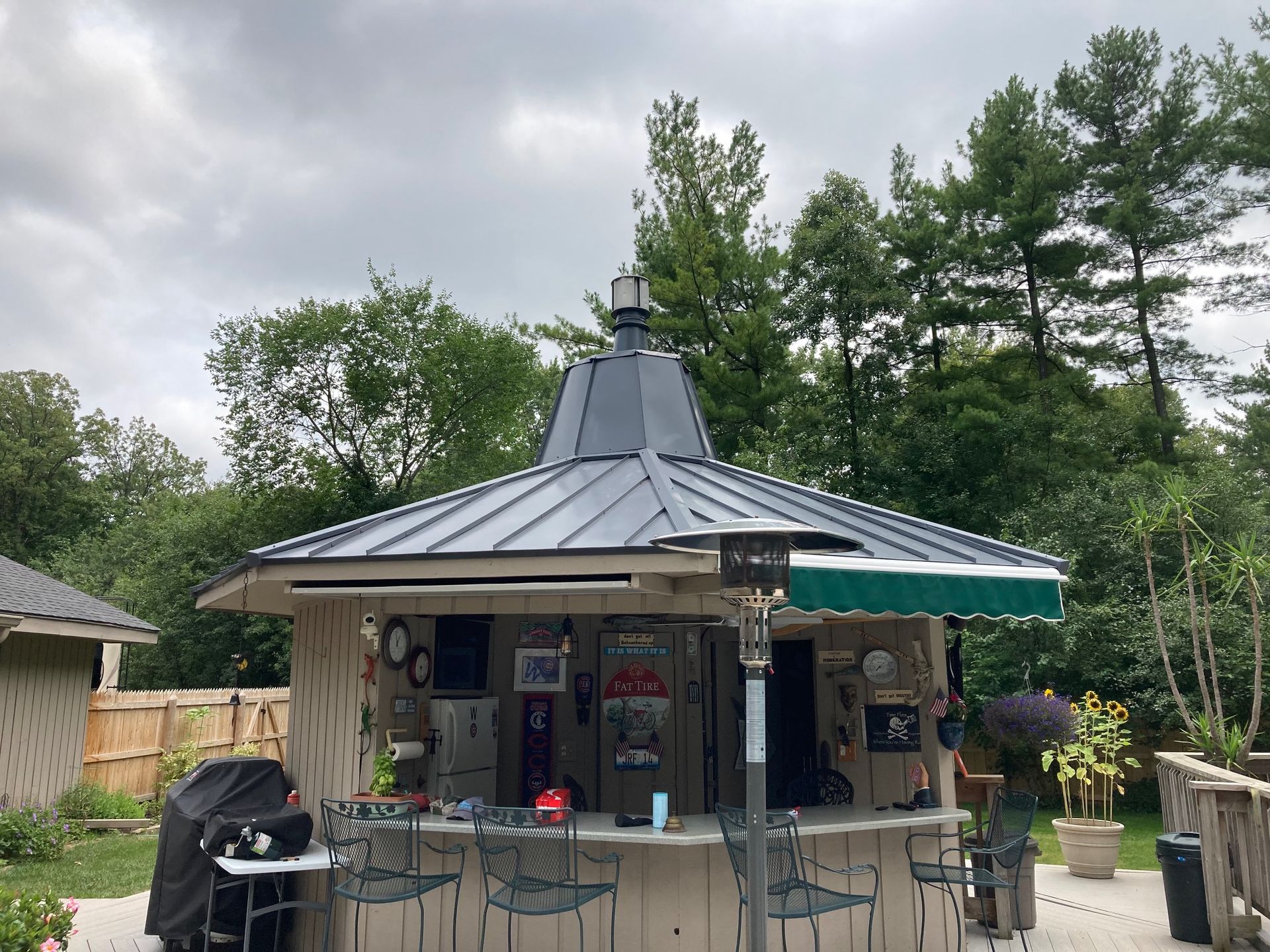 A gazebo with a roof that has a coca cola sign on it