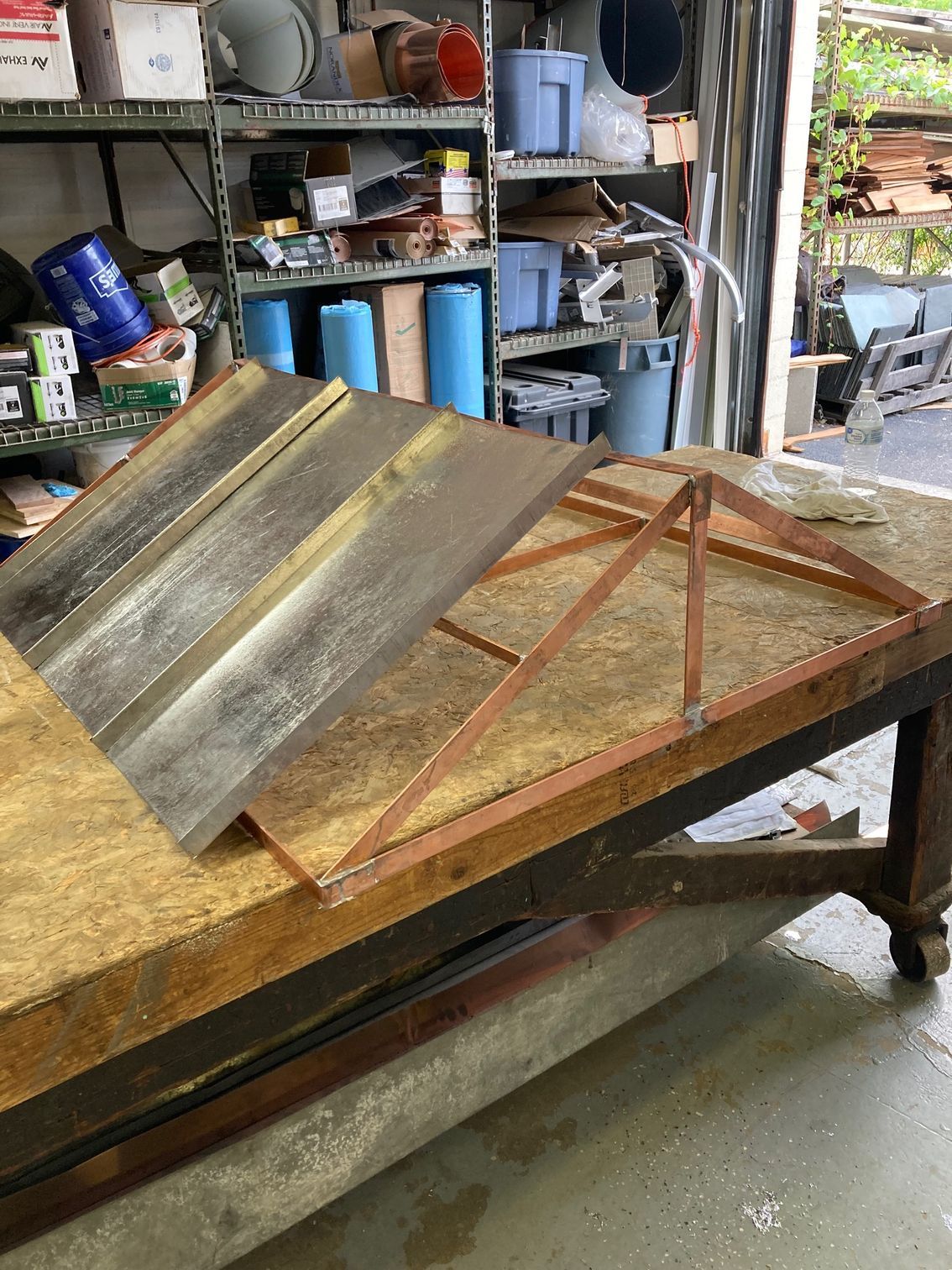 A piece of metal is sitting on top of a wooden table.