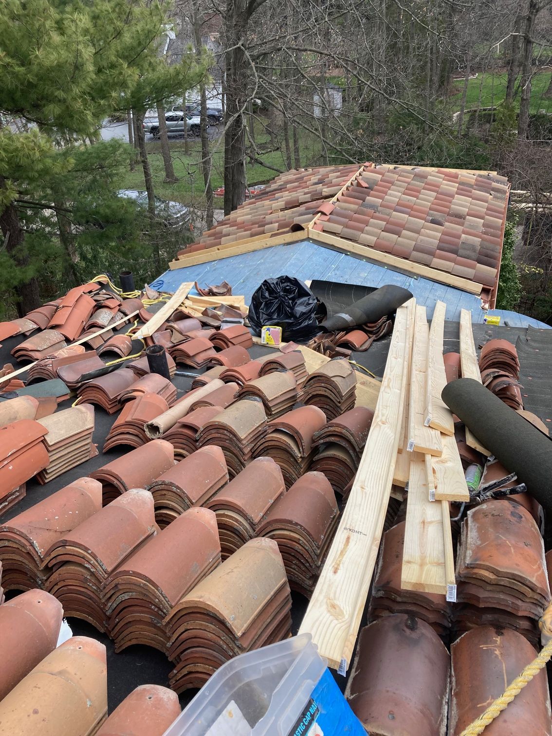 A roof with a lot of tiles and wood on it