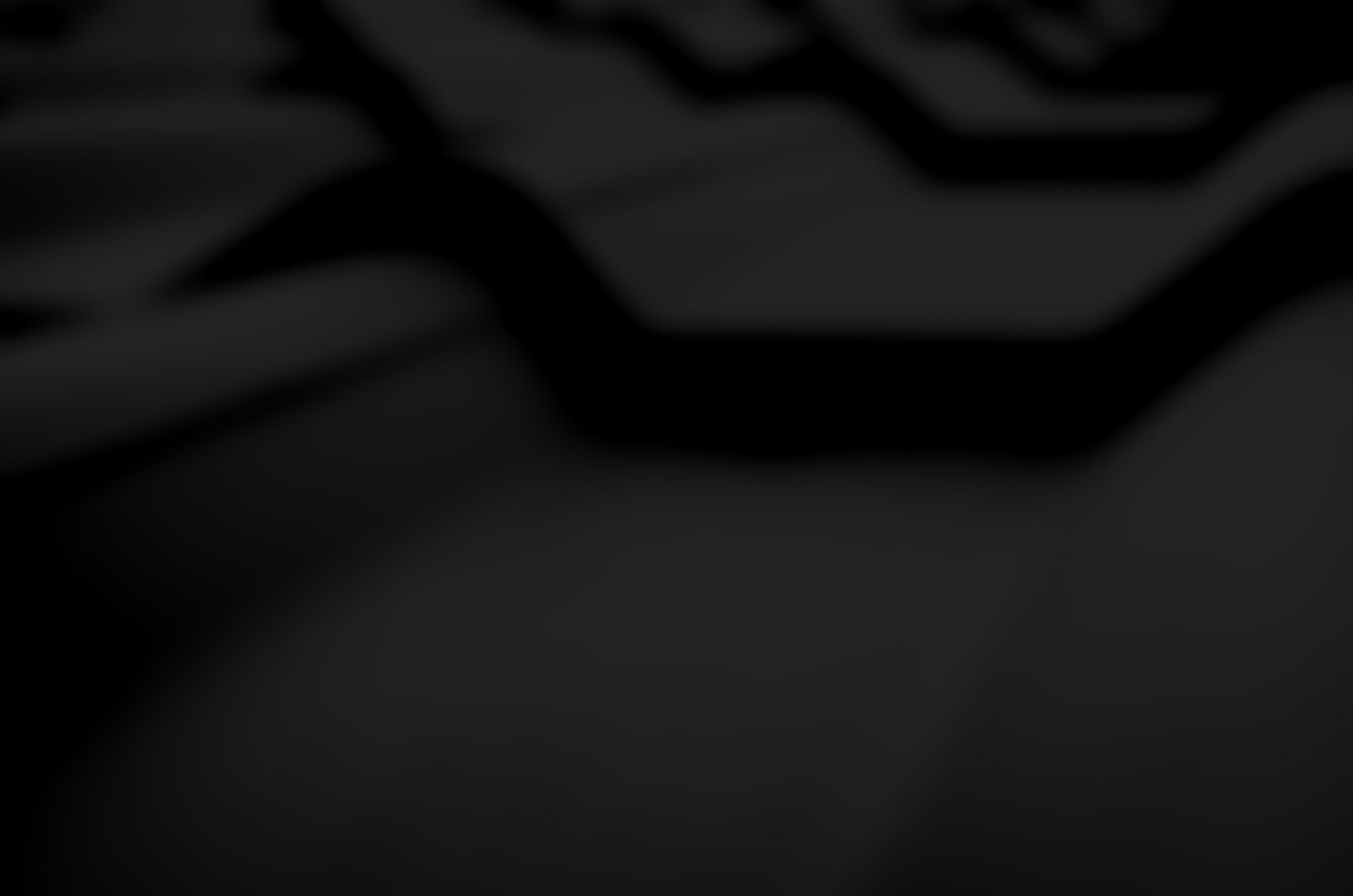 A close up of a black roof with a screw in it.