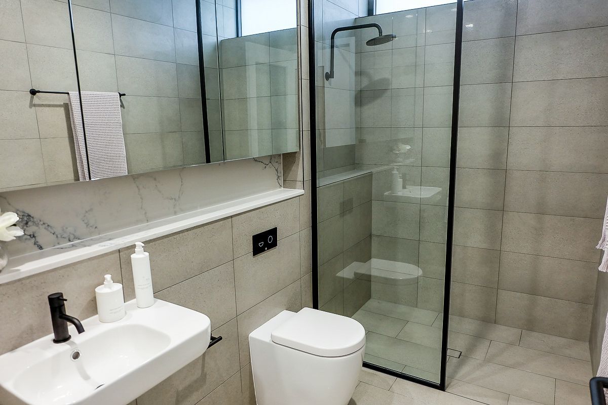 Hexagon feature tile shower wall with matte black fixtures – Pelham bathroom