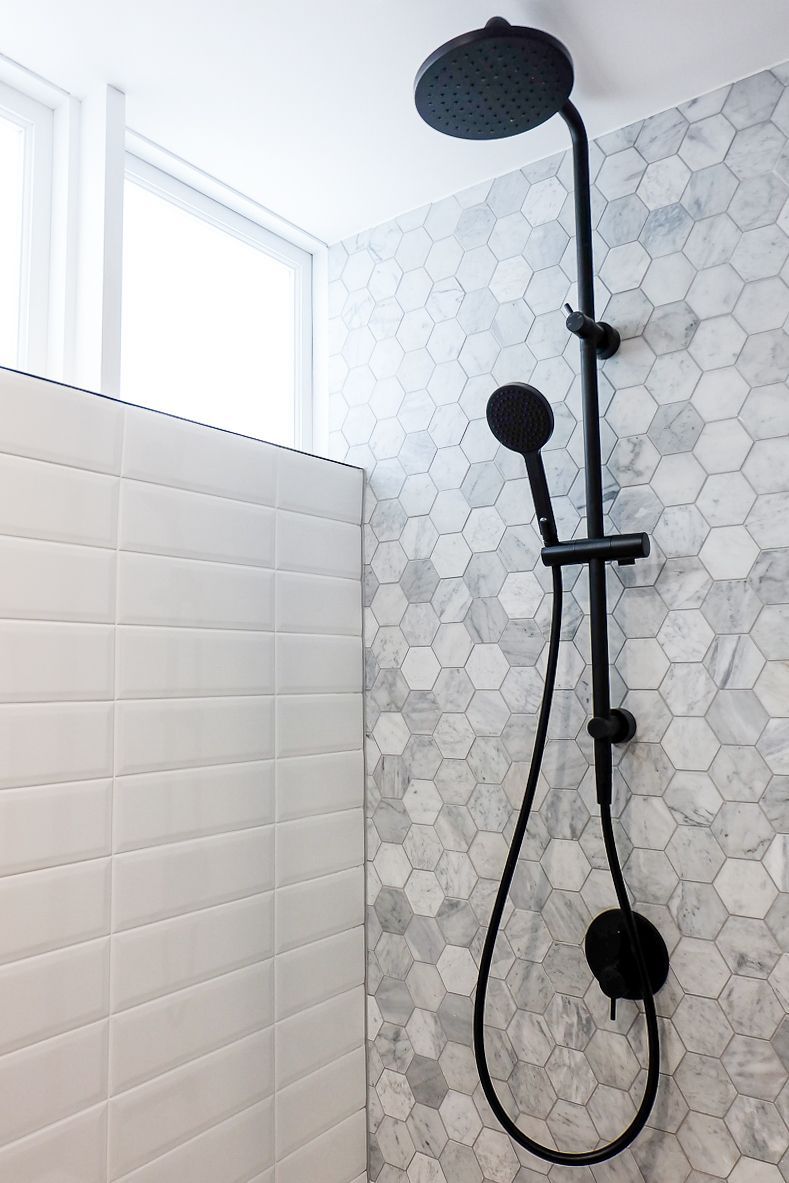 Bathroom with large-format tiles, black fixtures and walk-in shower – Pelham