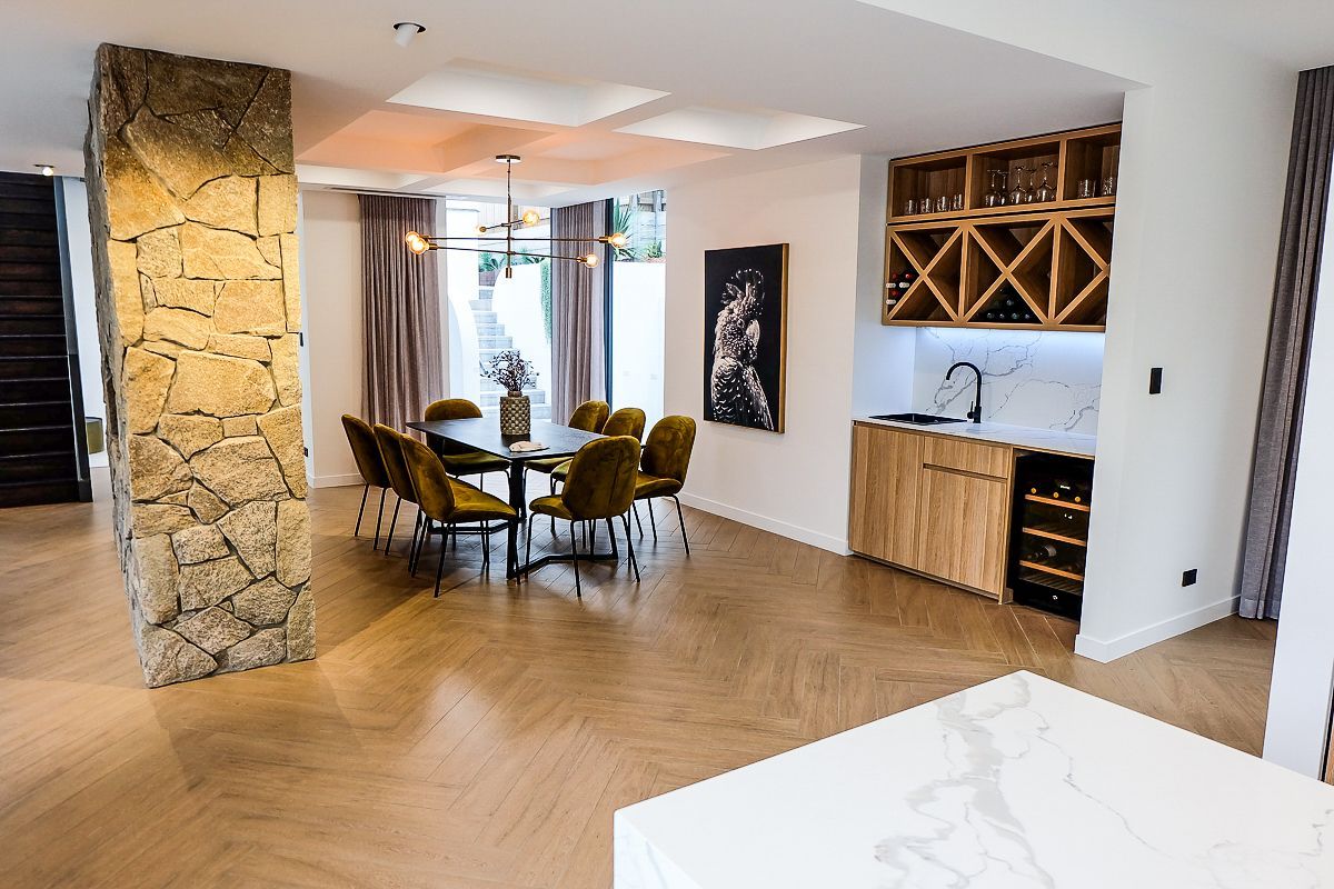 Dining area with stone feature column and herringbone tiles – Pelham home