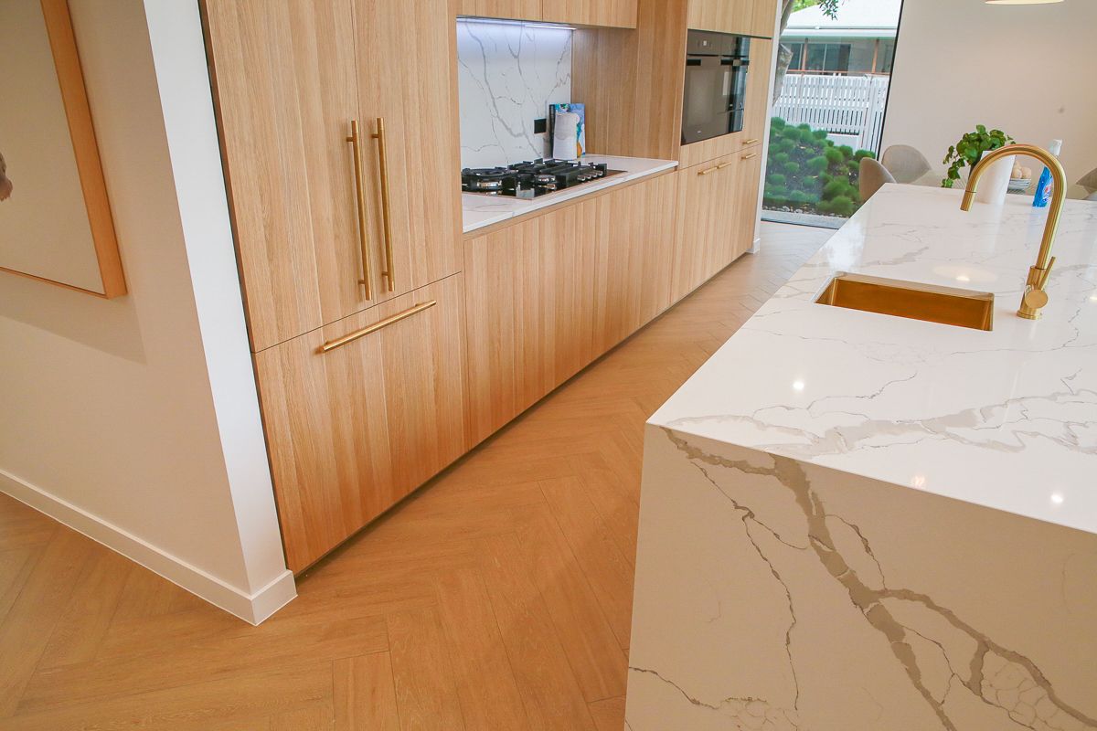 Herringbone timber-look tiled kitchen floor with stone island – Ascot home