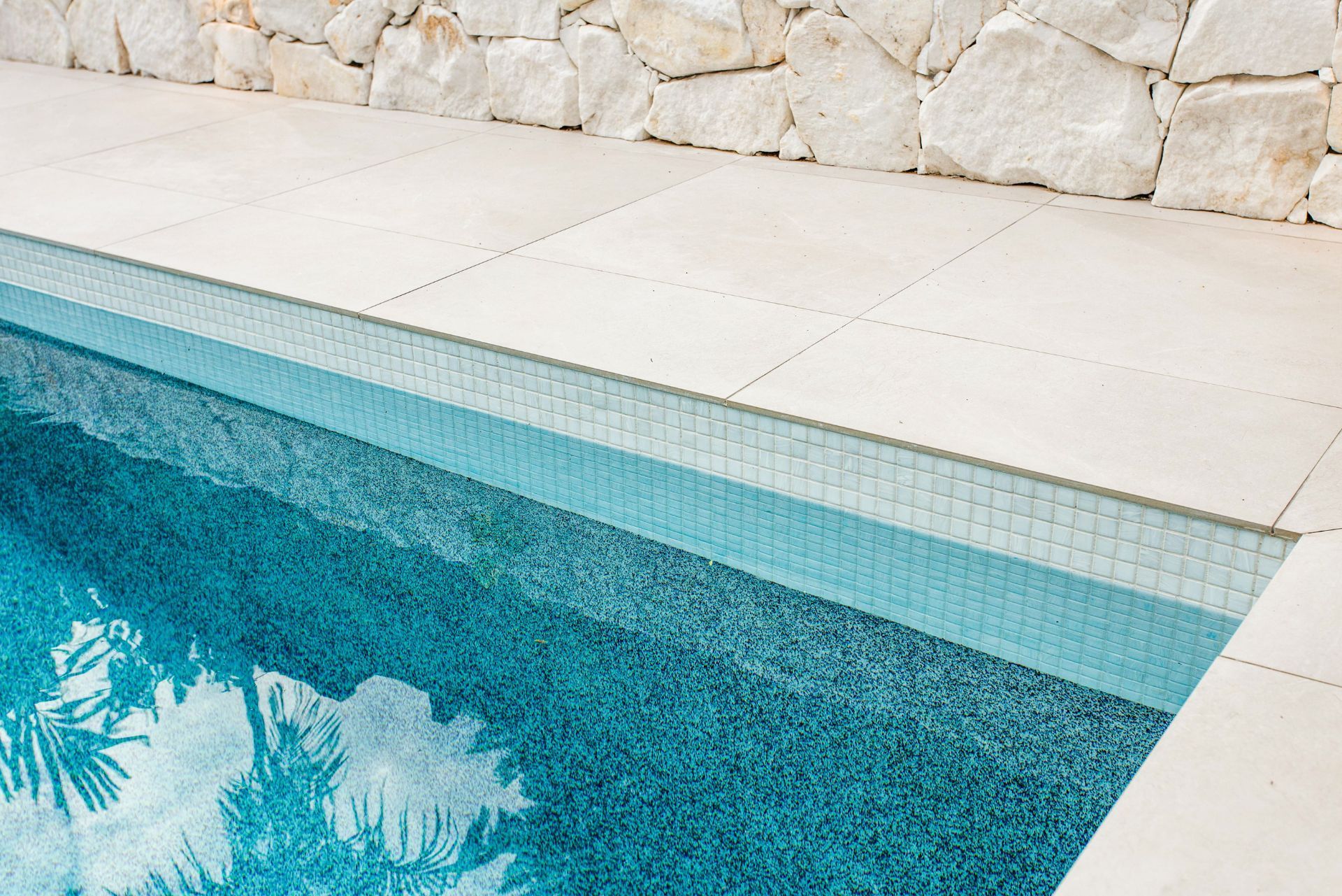 Pool coping tiles with light stone finish and clean grout lines – Camp Hill home