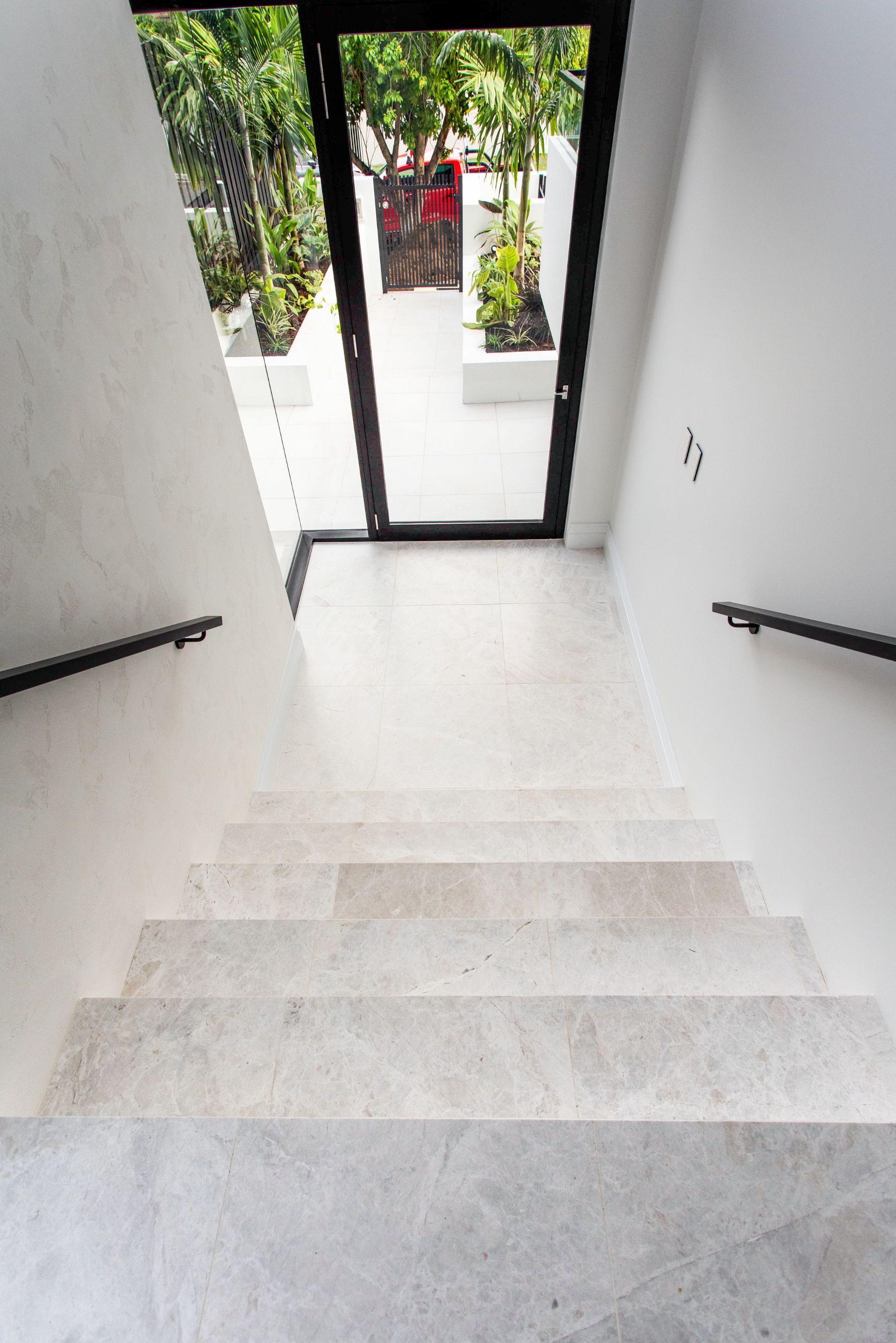 Tiled entry steps with clean fall and white render – Camp Hill residence