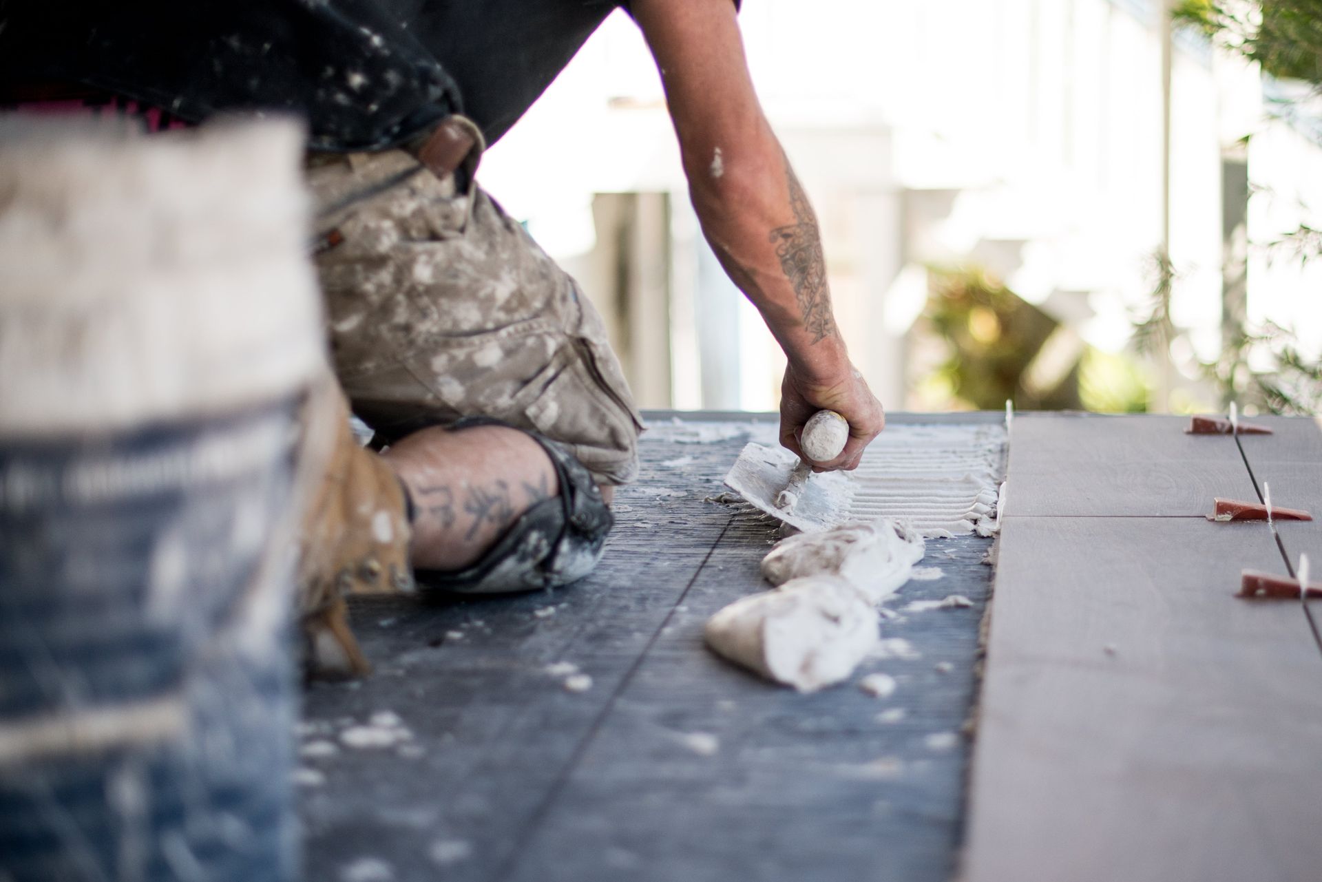 Tiler applying adhesive and setting mosaic tiles – Samford installation