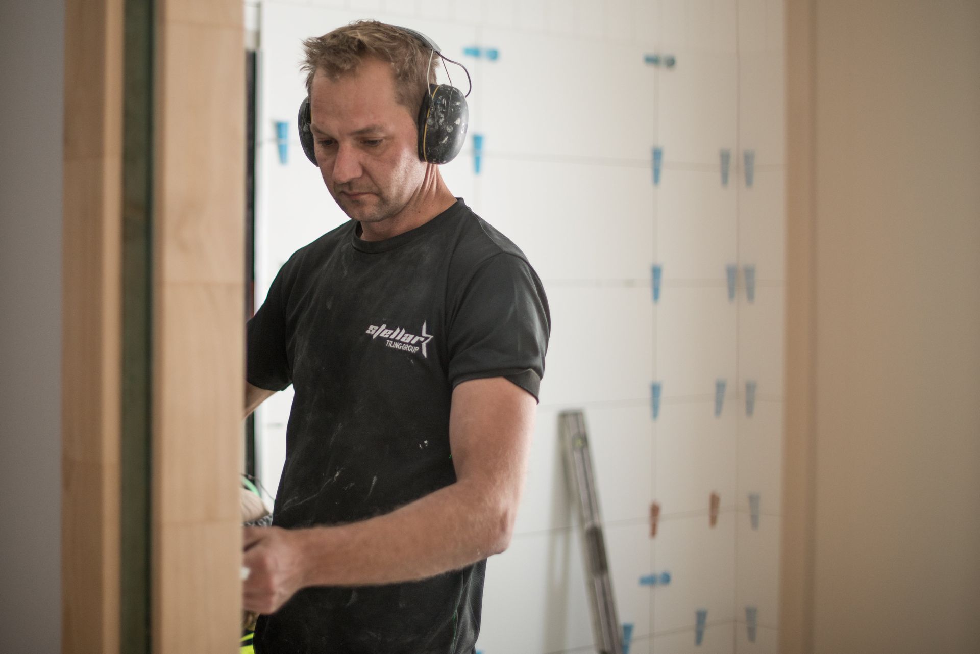 Erik completing bathroom tile installation on site – Pelham residential project