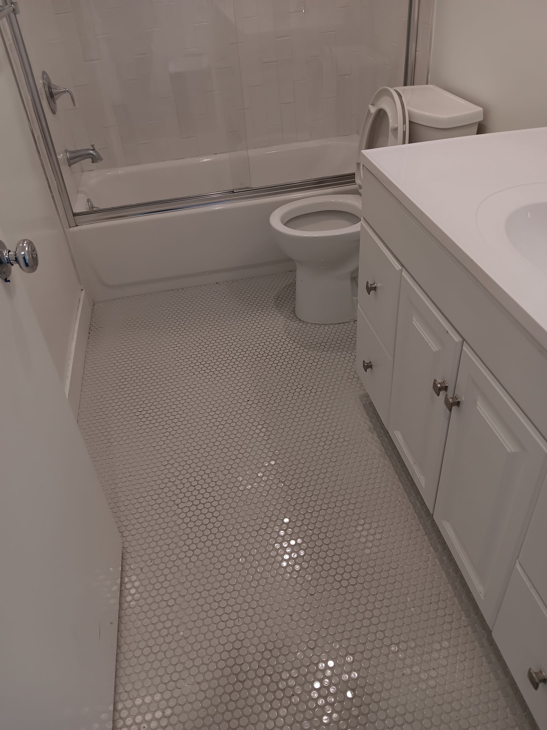 A bathroom with a toilet , sink , bathtub and shower.
