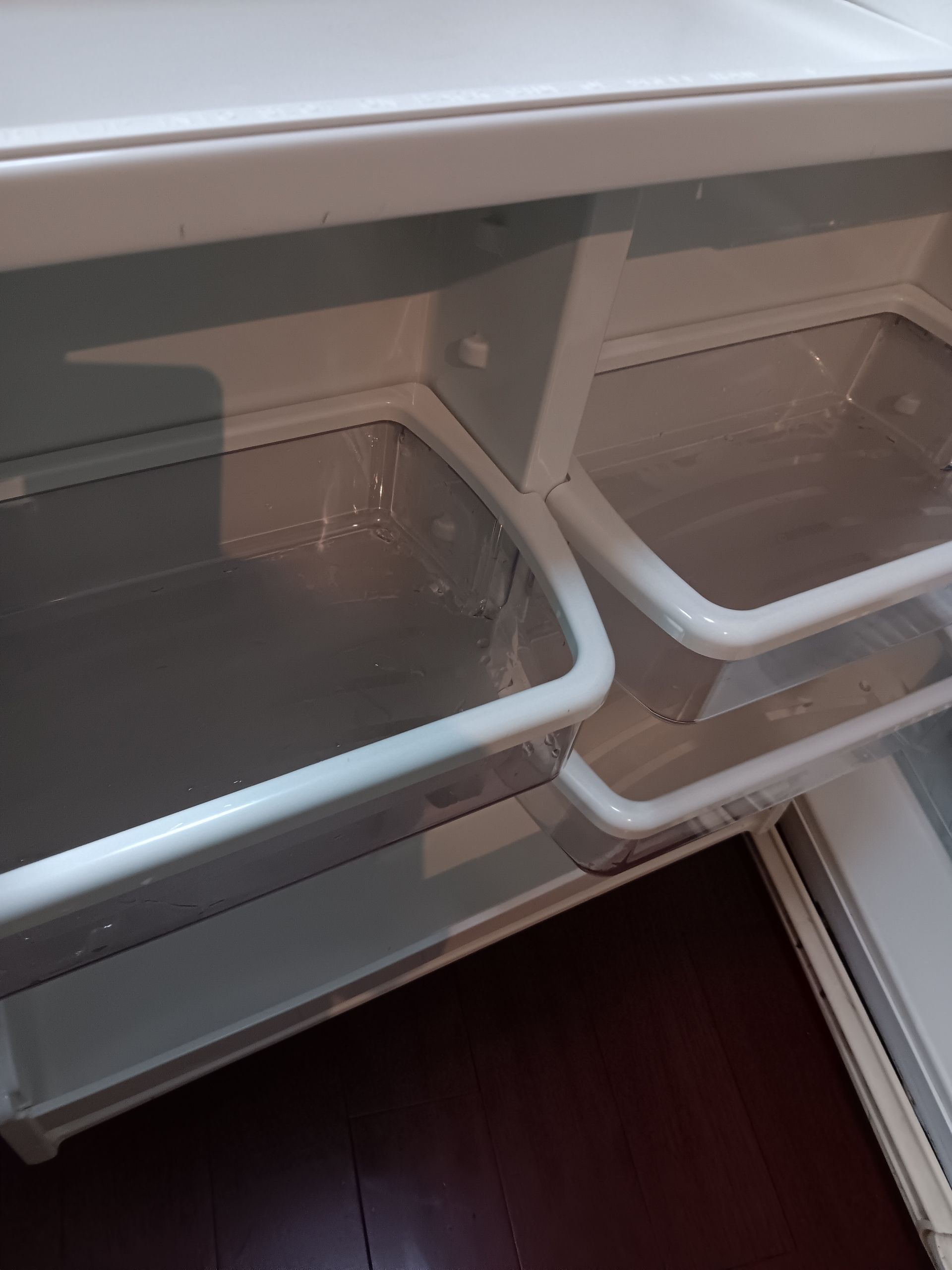 The inside of an empty refrigerator with the door open