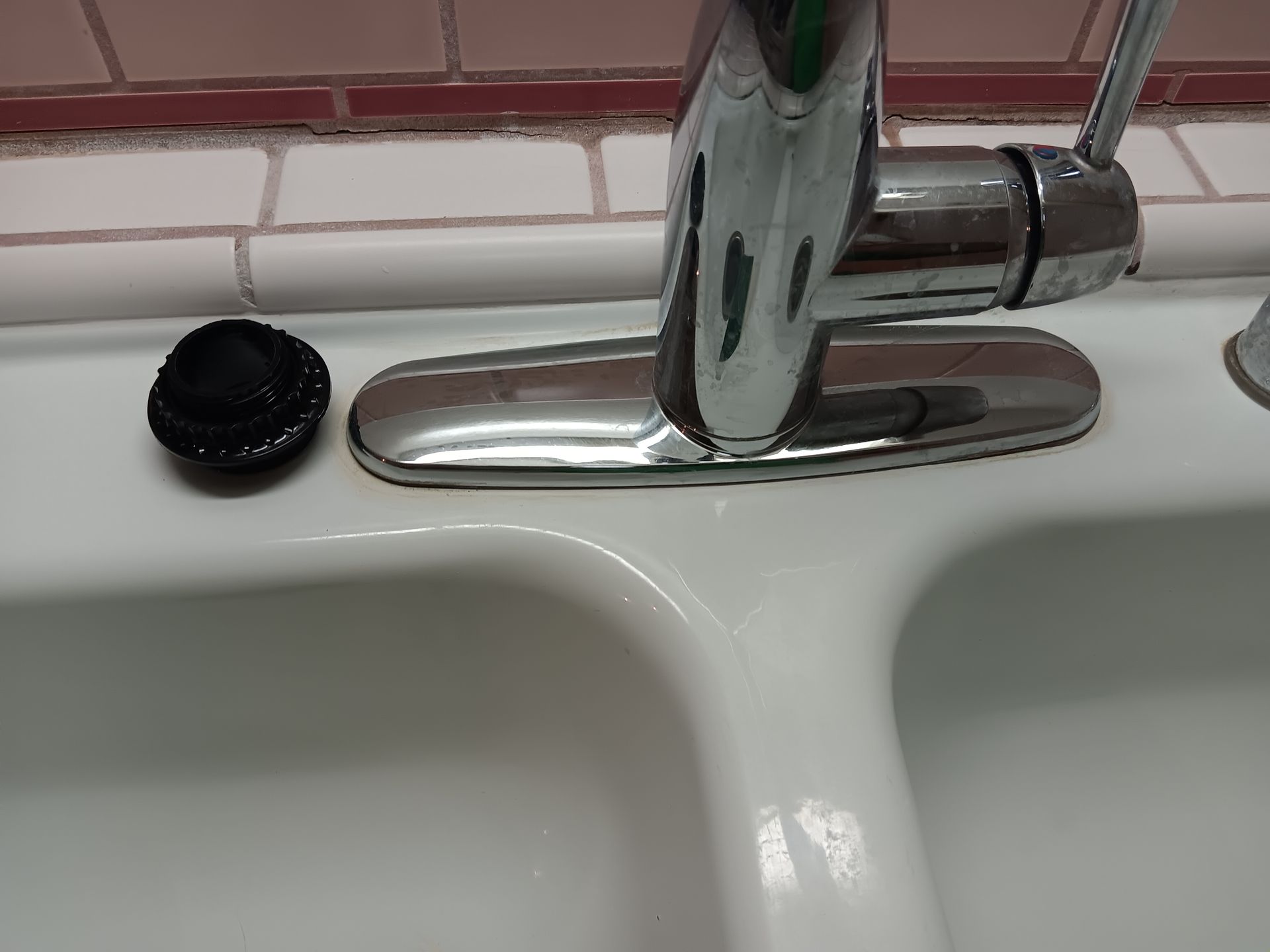 A close up of a kitchen sink with a faucet