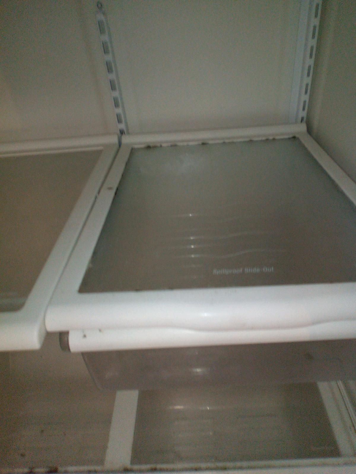 An empty refrigerator with a clear glass door