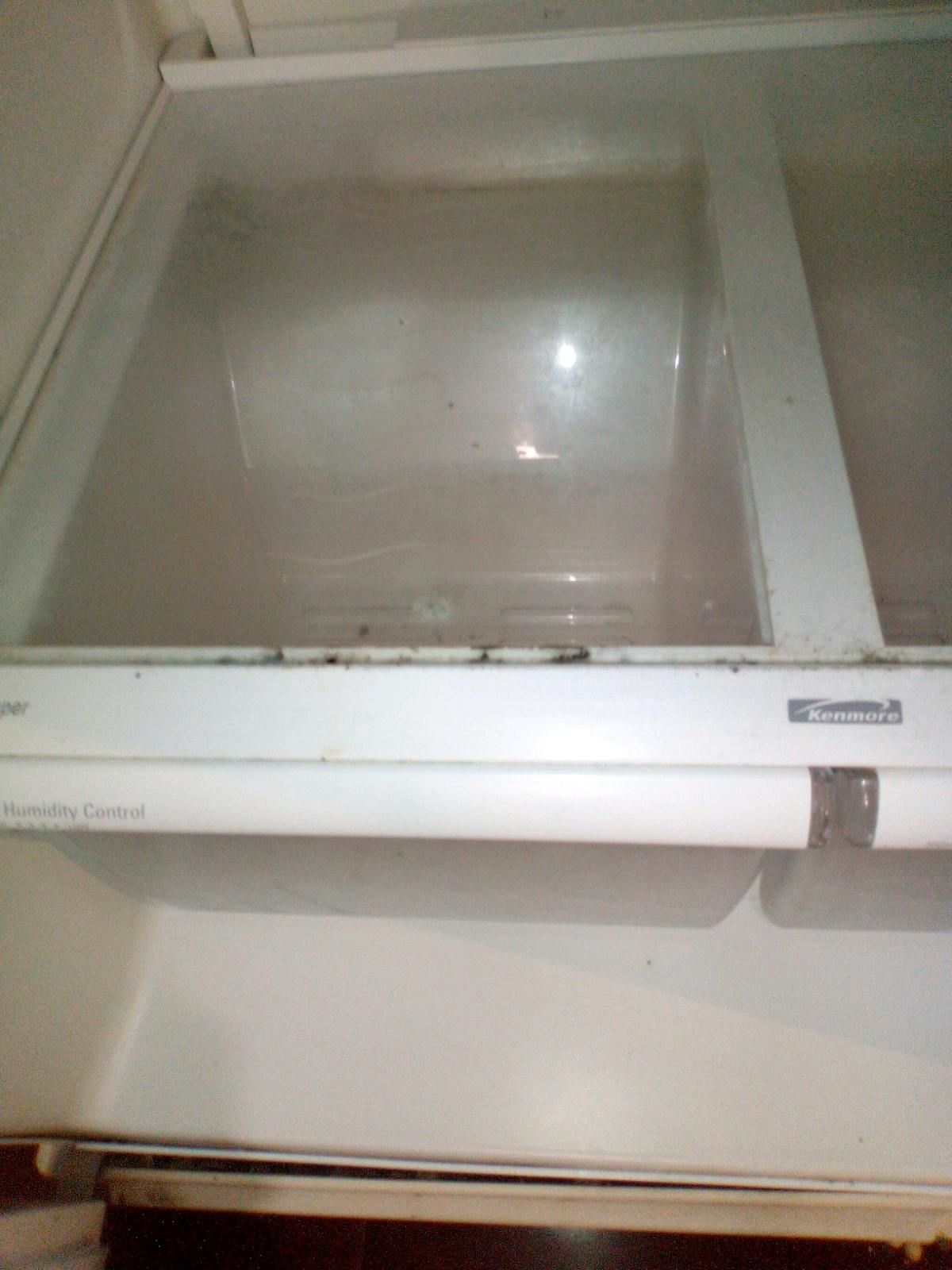 The inside of an empty refrigerator with a clear glass door.
