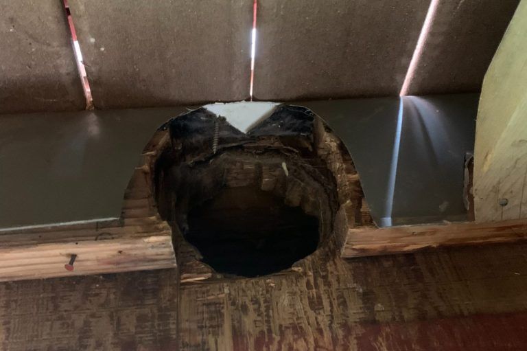 A hole in the ceiling of a building with a hole in it.