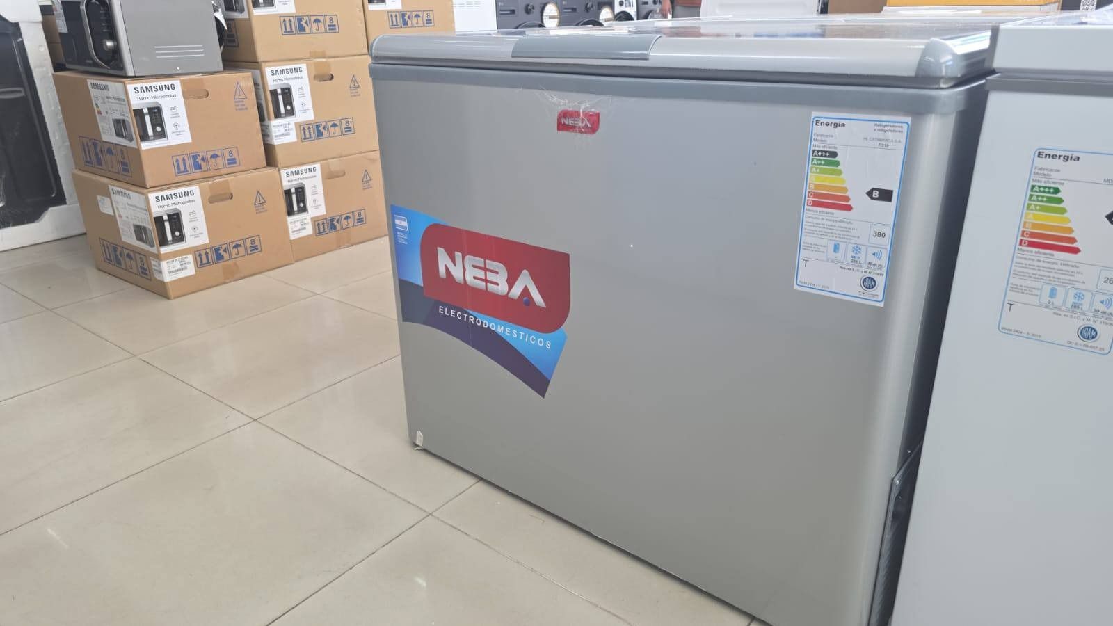 Interior de una tienda con refrigeradores, electrodomésticos y un anuncio de 