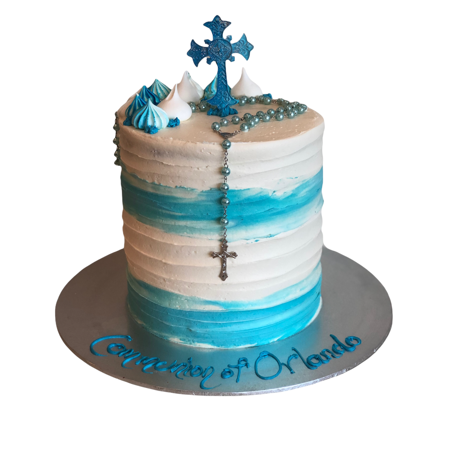 white and blue stacked cake with blue details and cross