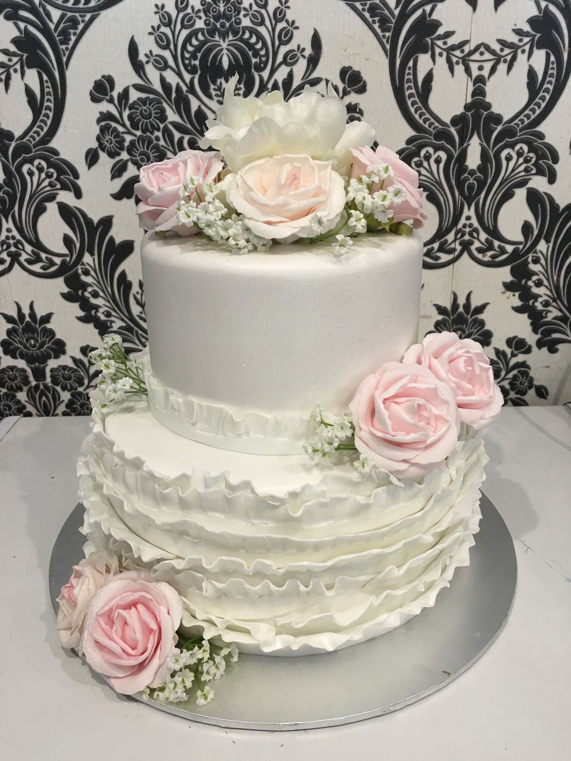 white double tier wedding cake with roses