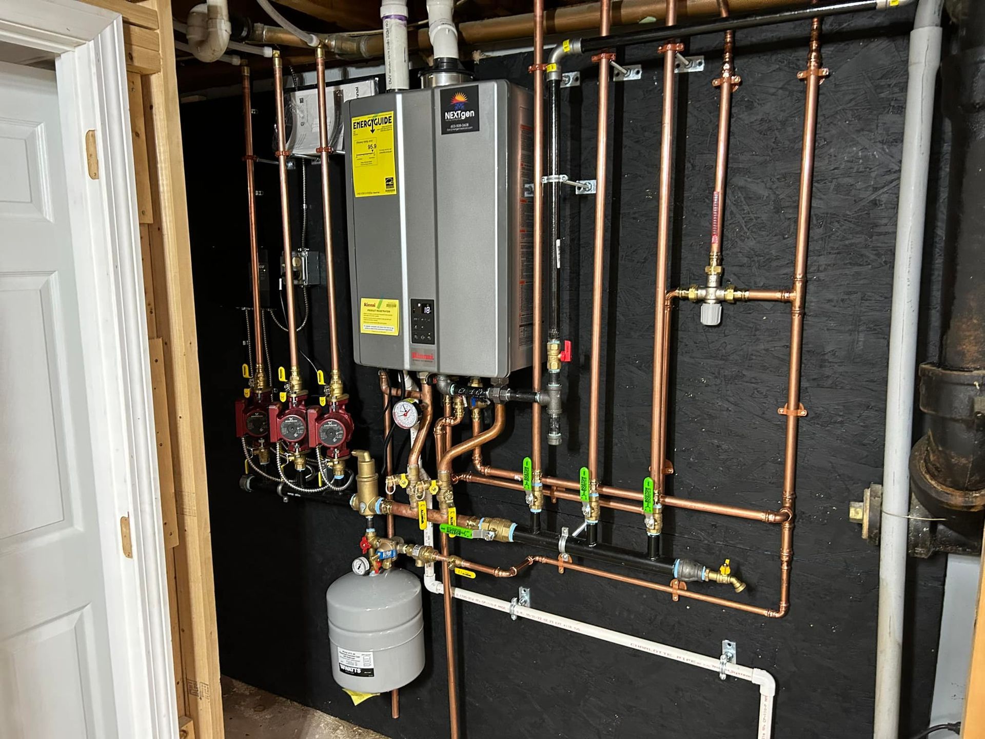 A room with a lot of pipes and a water heater