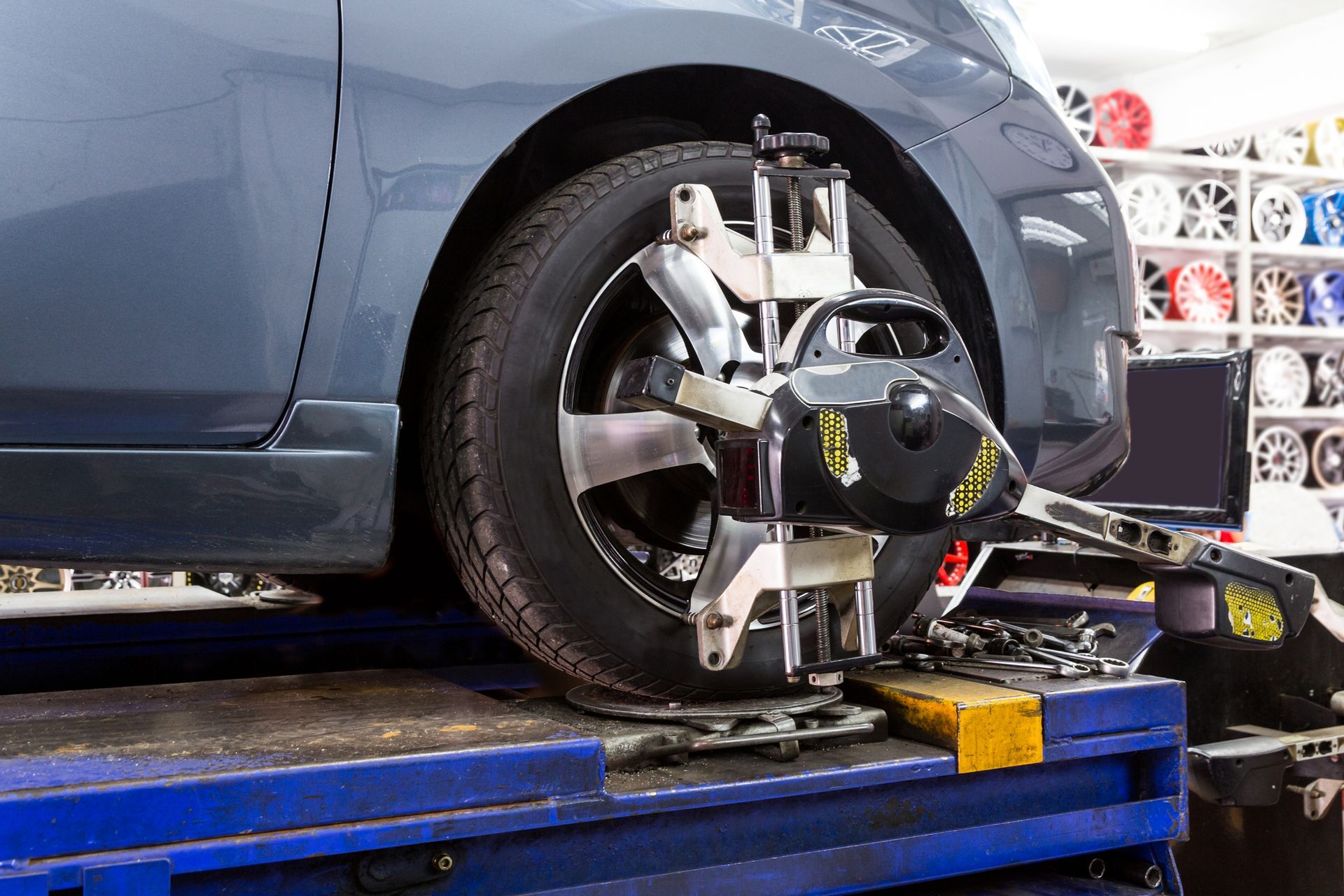 A car is being aligned with a machine in a garage.