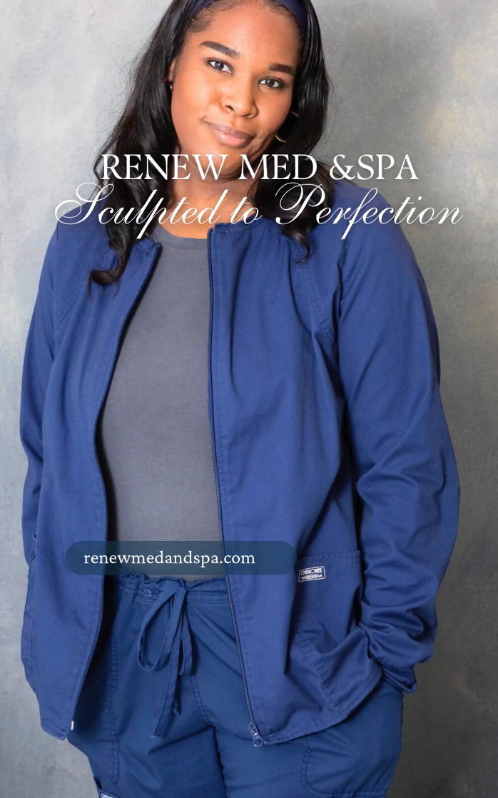 A woman wearing a blue jacket and pants is standing with her hands in her pockets.