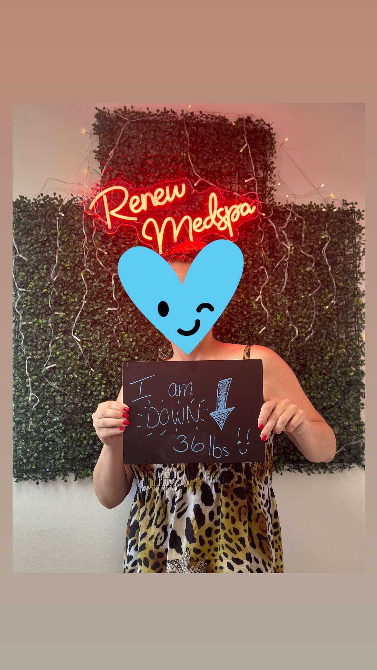 A woman is holding a sign in front of a neon sign that says renew madspa.