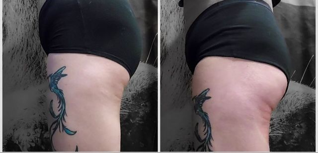 A woman with a tattoo on her leg is wearing black underwear.