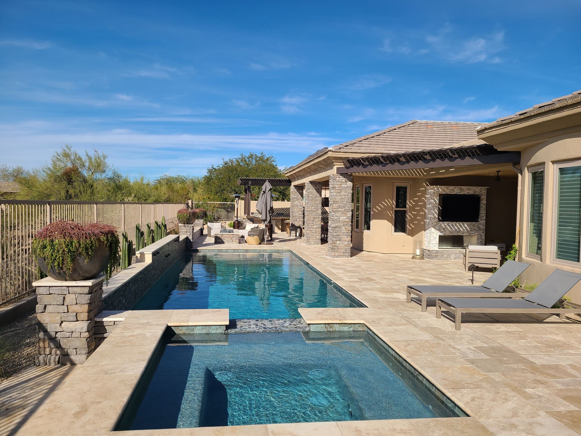 A patio with a pergola and stone steps