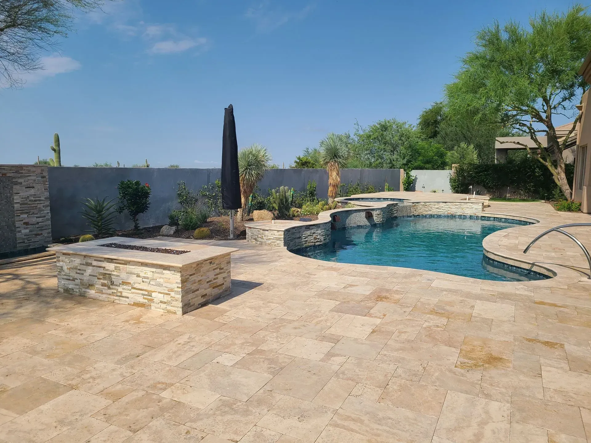 A patio with a pergola and stone steps