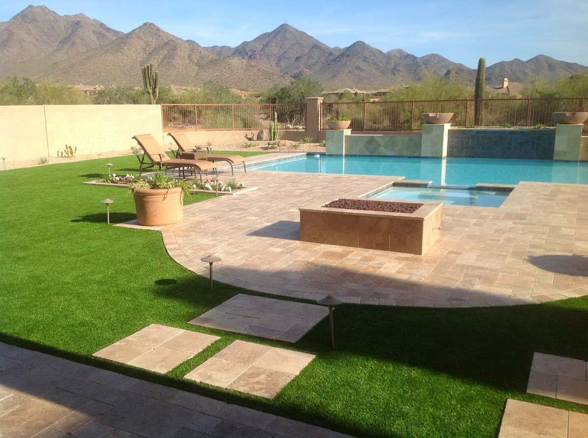 A backyard with a swimming pool and a fire pit