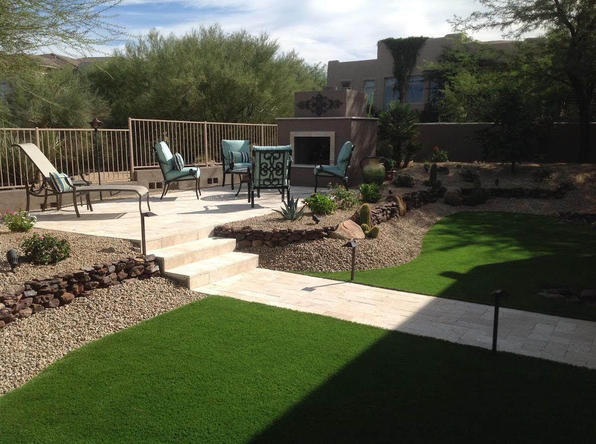 A backyard with a patio and chairs in it