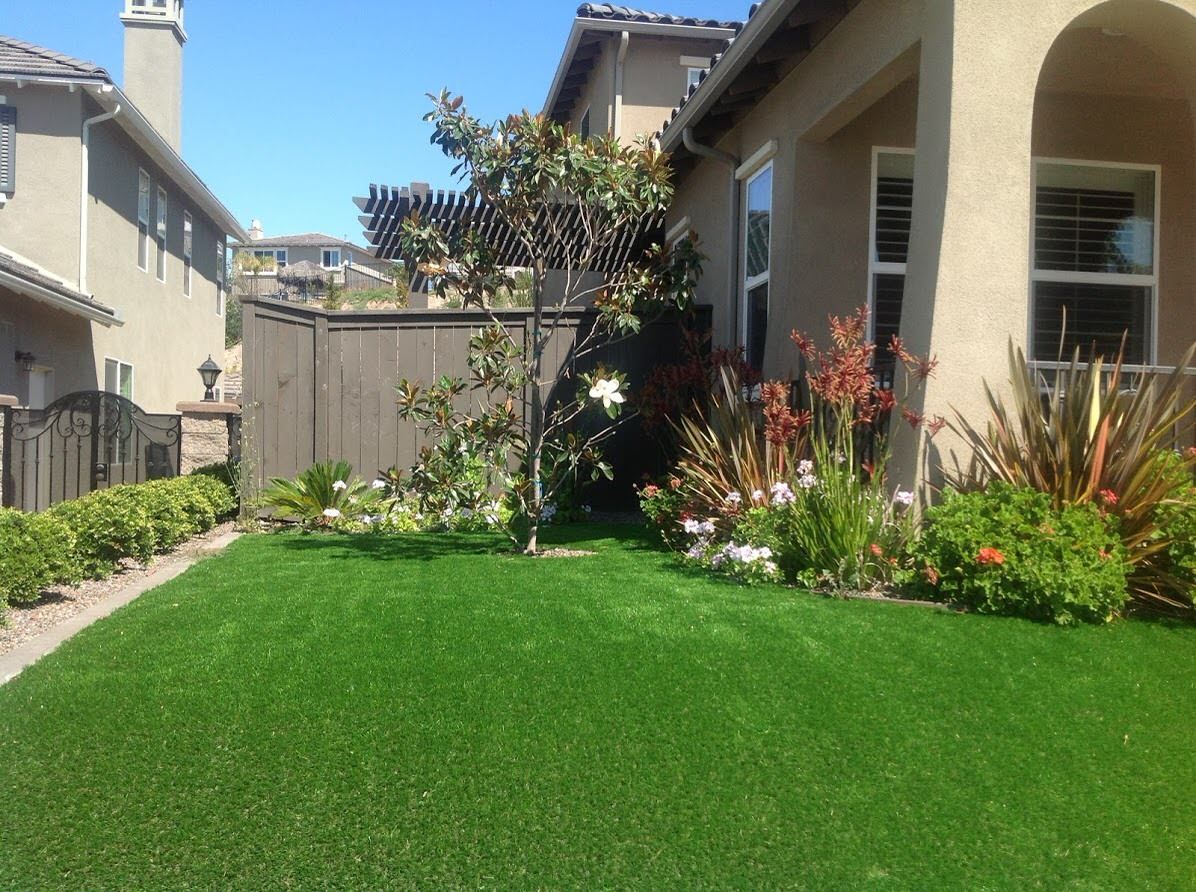 A house with a lush green lawn in front of it