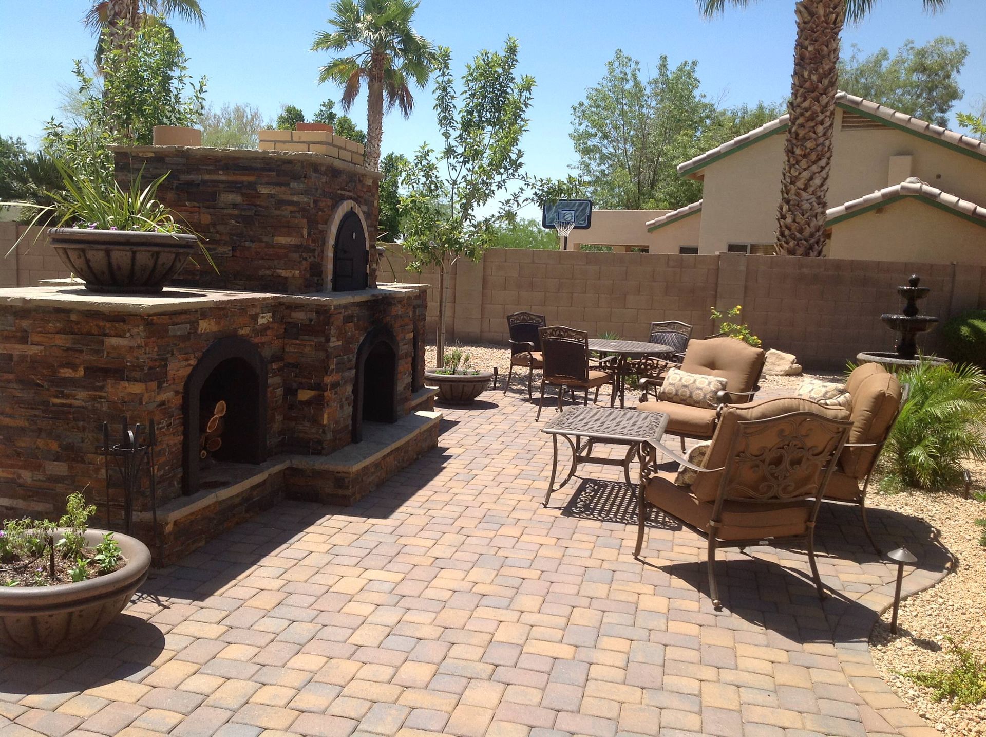 A patio with a fireplace and a table and chairs