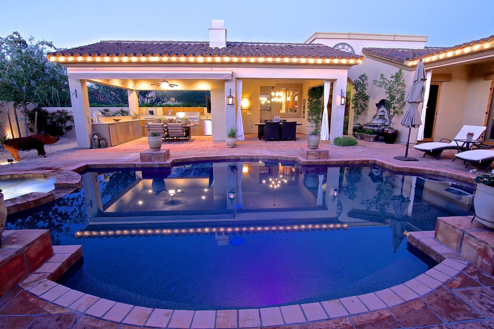 A house with a large swimming pool in front of it