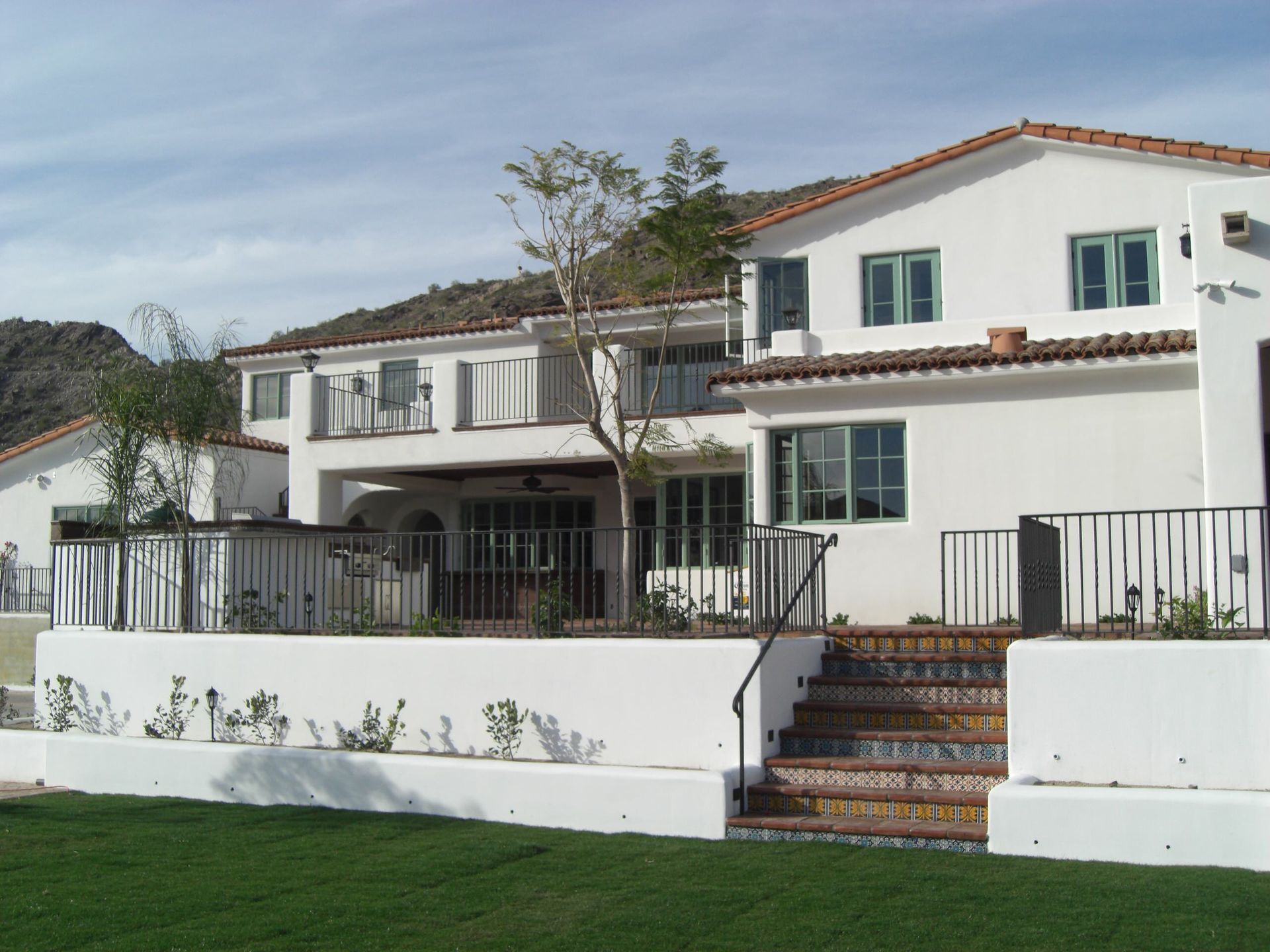 A large white house with stairs leading up to it