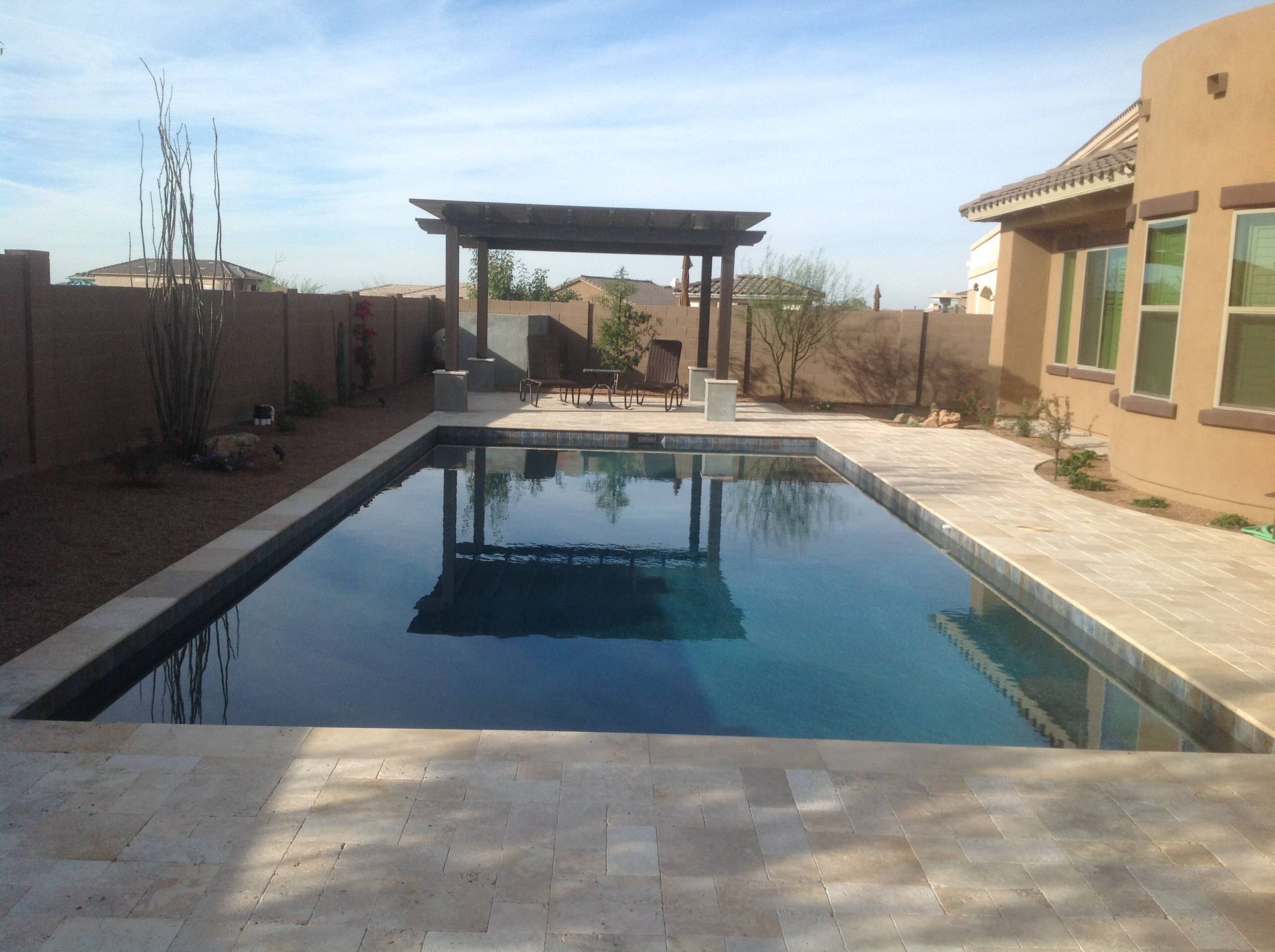 A large swimming pool in the backyard of a house