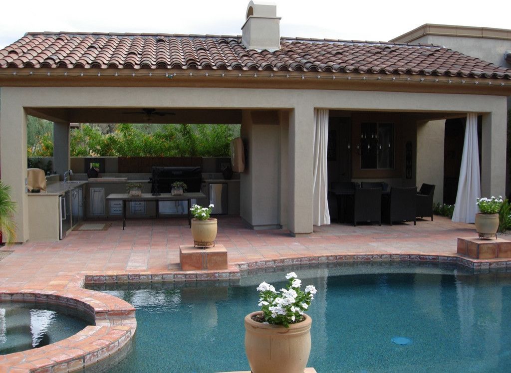 A house with a swimming pool in front of it