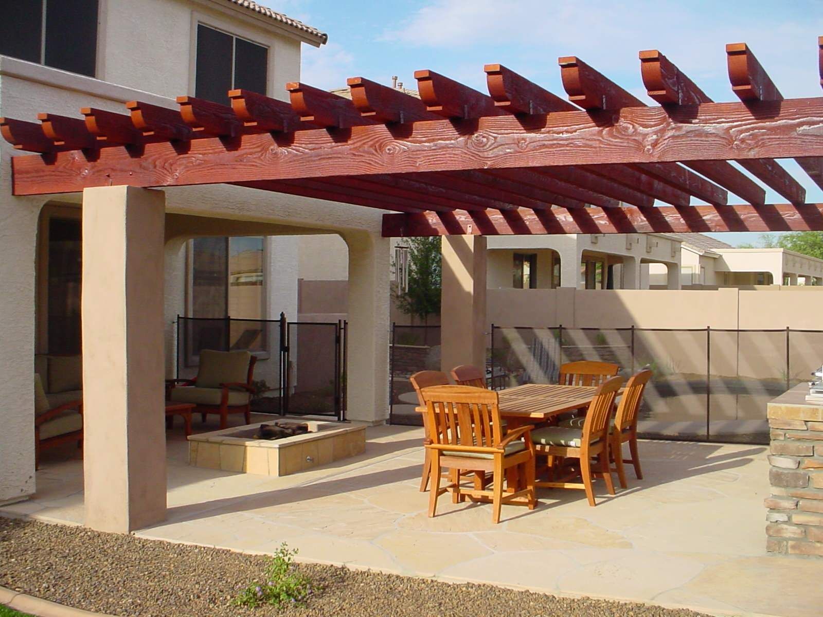 A patio with a table and chairs under a pergola