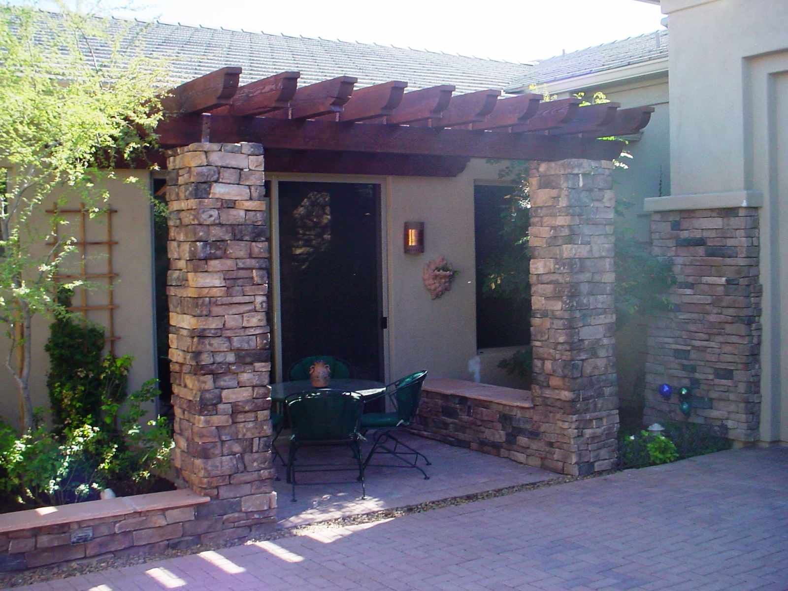A patio with a table and chairs under a pergola