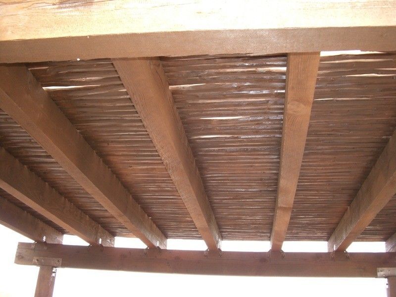 A wooden structure with a roof made of bamboo
