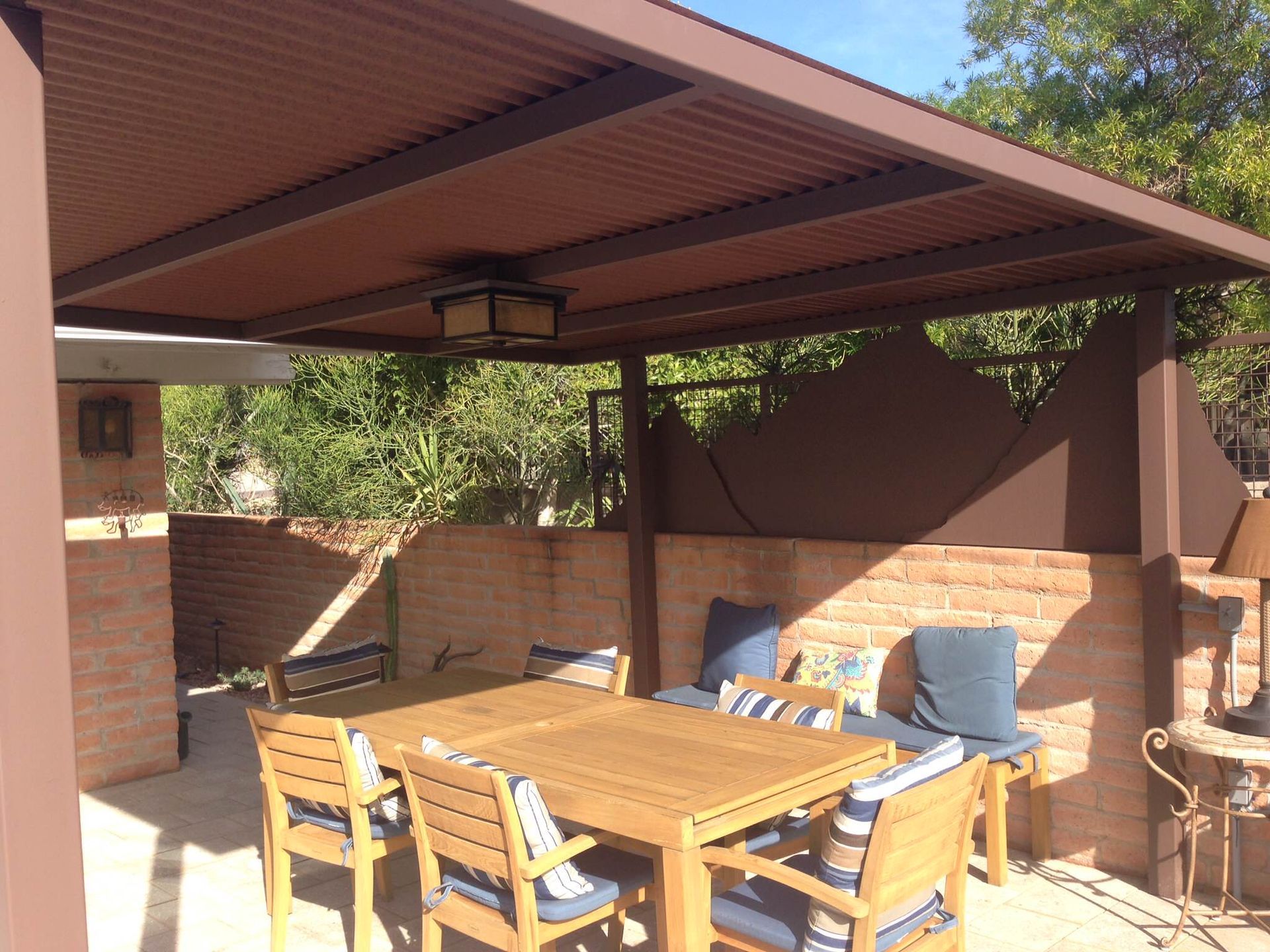 A patio with a table and chairs under a canopy