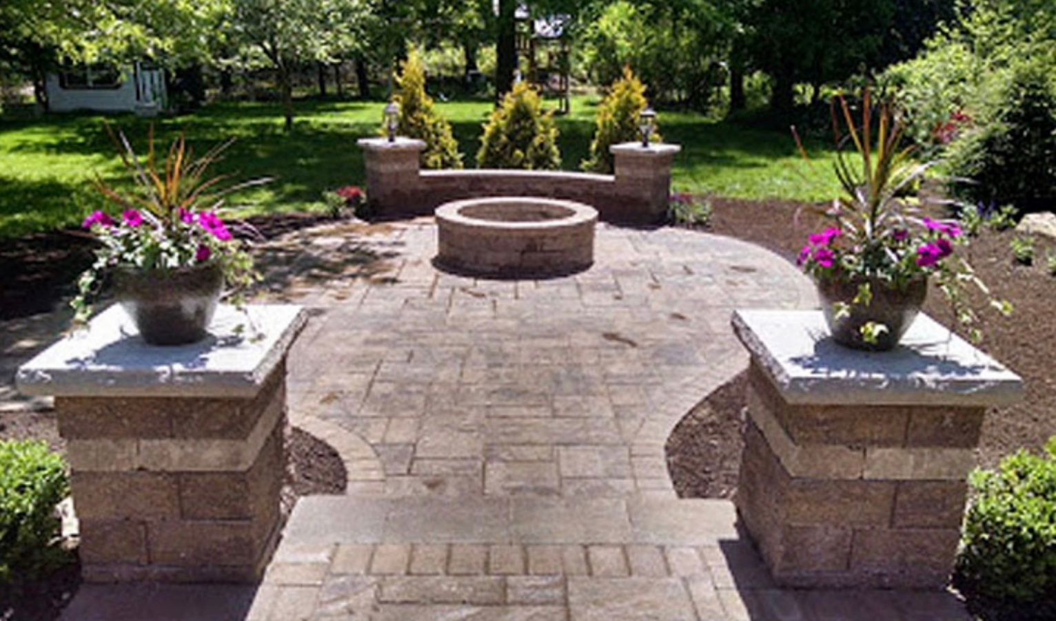 There is a fire pit in the middle of the patio.