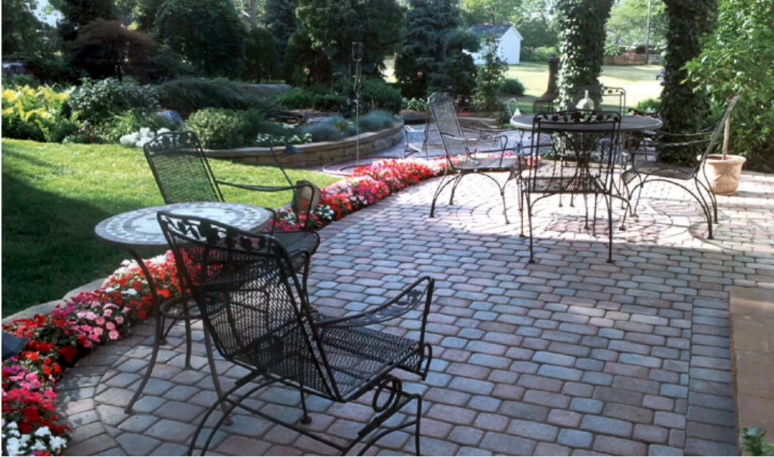 A patio with a table and chairs on it