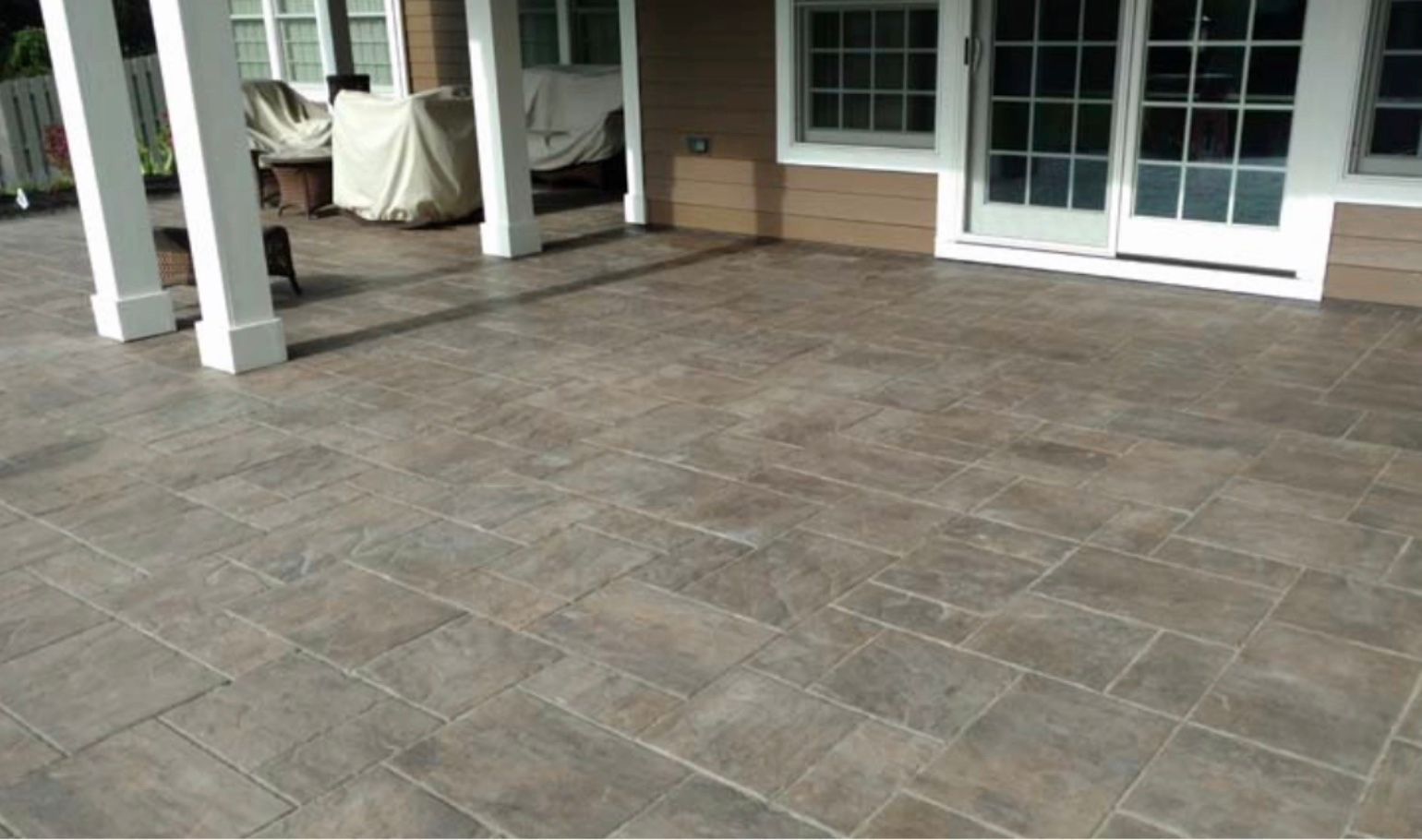 A patio with tiles and a sliding glass door