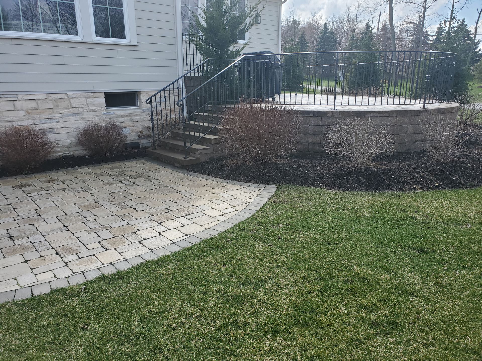 A house with a patio and stairs in front of it.