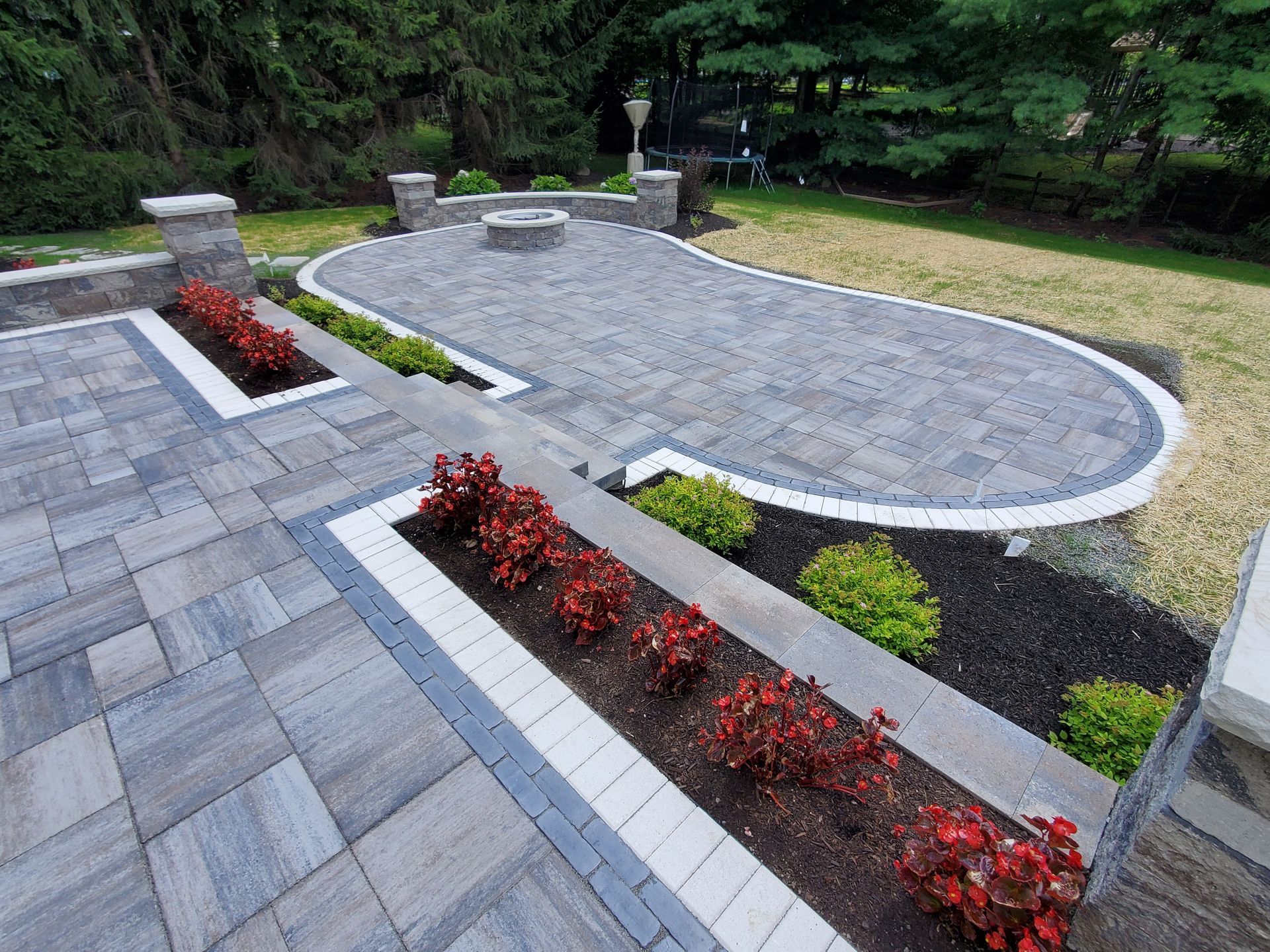 A patio with a fire pit in the middle of it