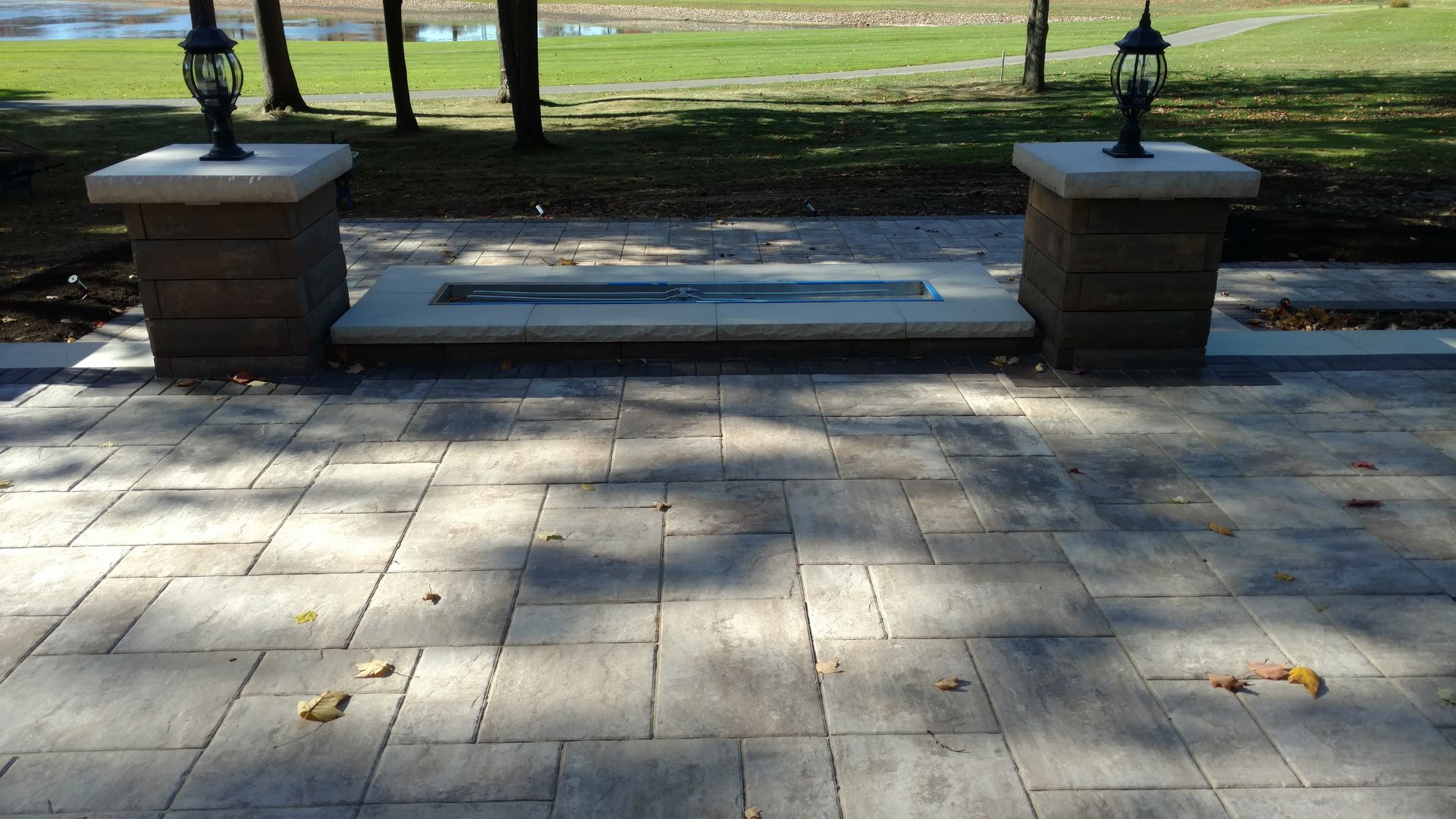 A patio with a fire pit in the middle of it