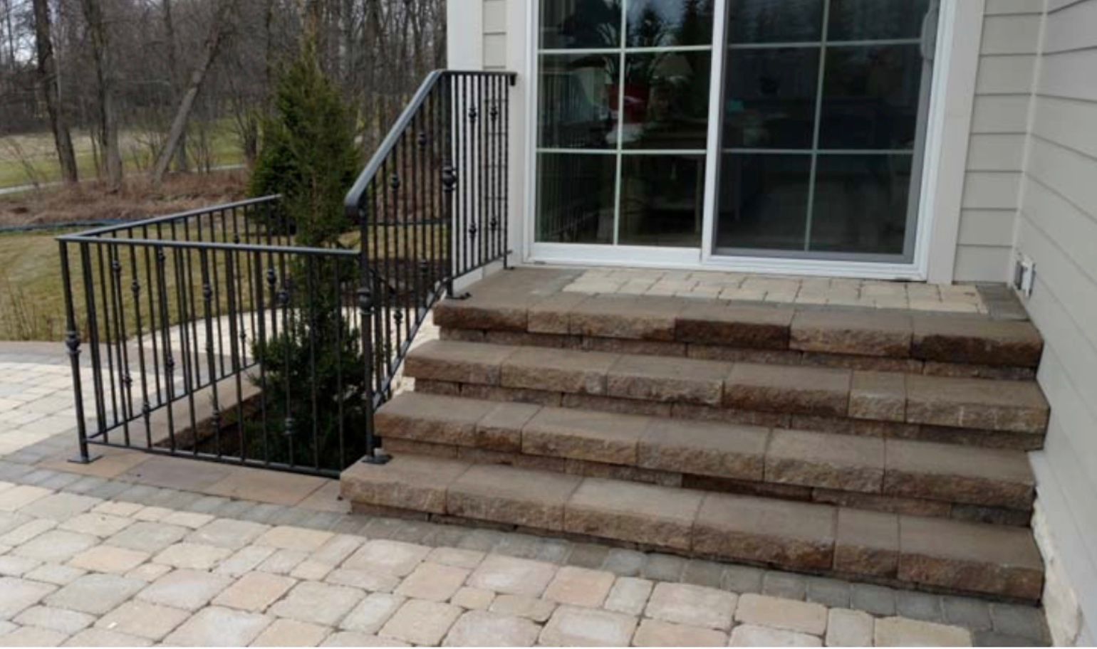 A set of stairs leading up to a sliding glass door