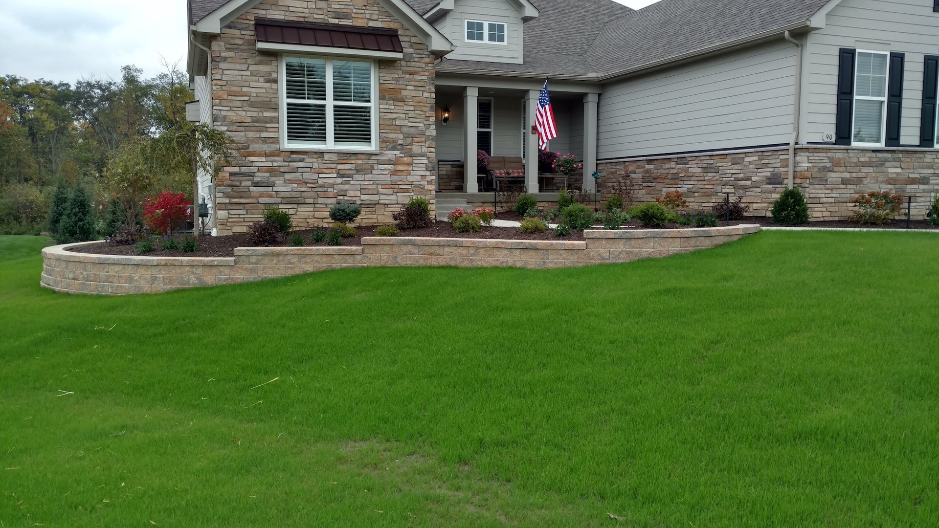 A large house with a large lawn in front of it.