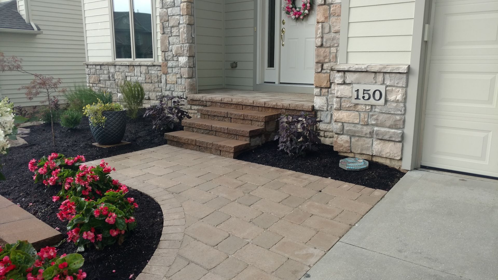 A brick walkway leading to the front door of a house.